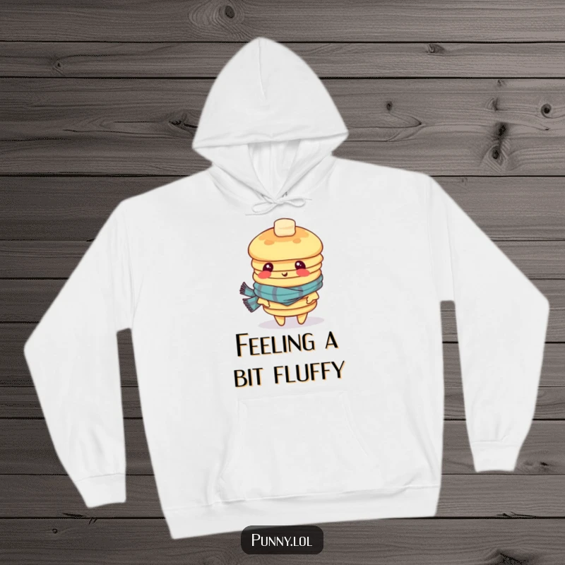 Funny hoodie depicting a dizzy stack of pancakes in a scarf, looking disoriented, making it a warm and humorous apparel choice.
