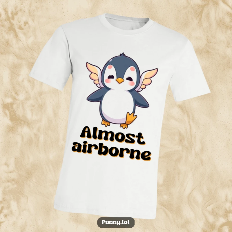 Funny t-shirt showcasing a silly penguin flapping its tiny, colorful wings in a determined, yet humorous, effort to take flight.
