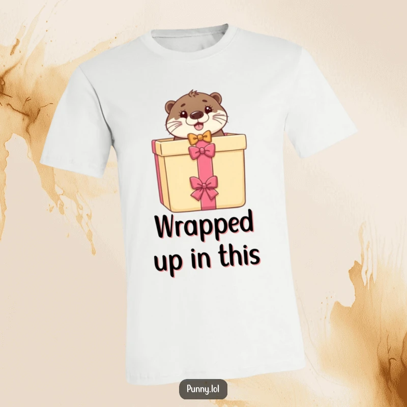 Funny t-shirt featuring a happy otter in a bow tie popping out of a large gift box, ideal for casual wear.