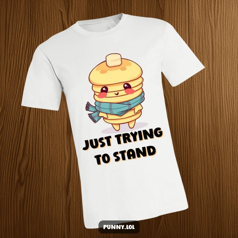 Funny t-shirt showcasing a wobbly stack of pancakes wearing a scarf and looking dizzy, embodying breakfast chaos and quirky fun.